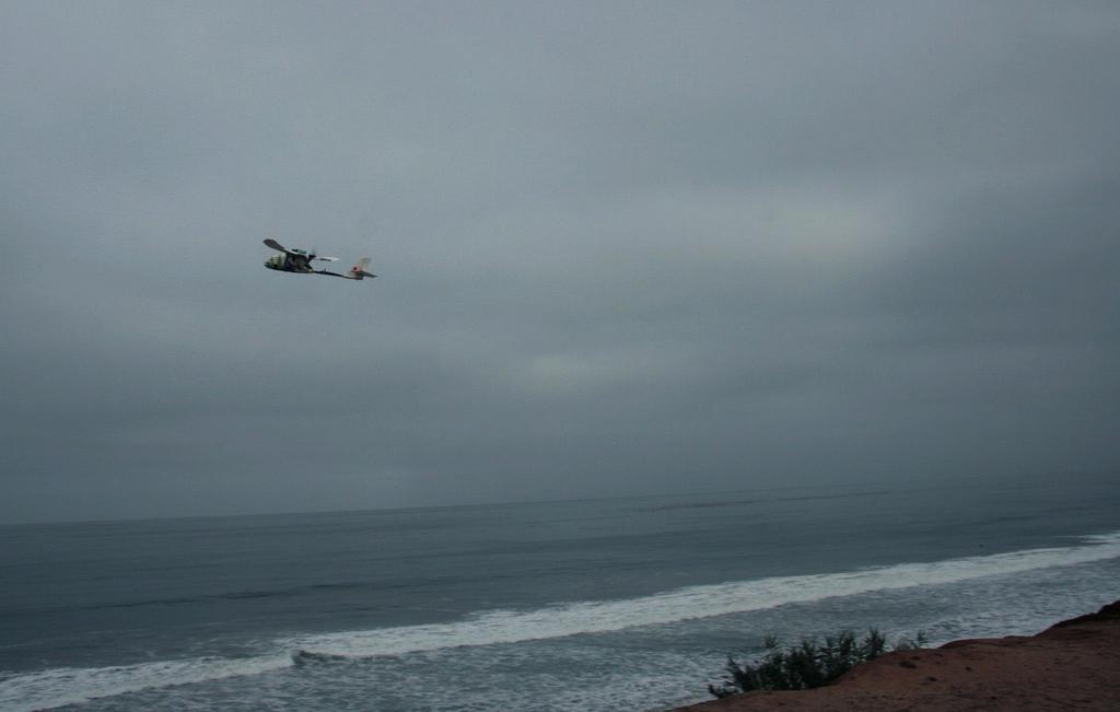 Aero flying over ocean taking aerial photos of surfers